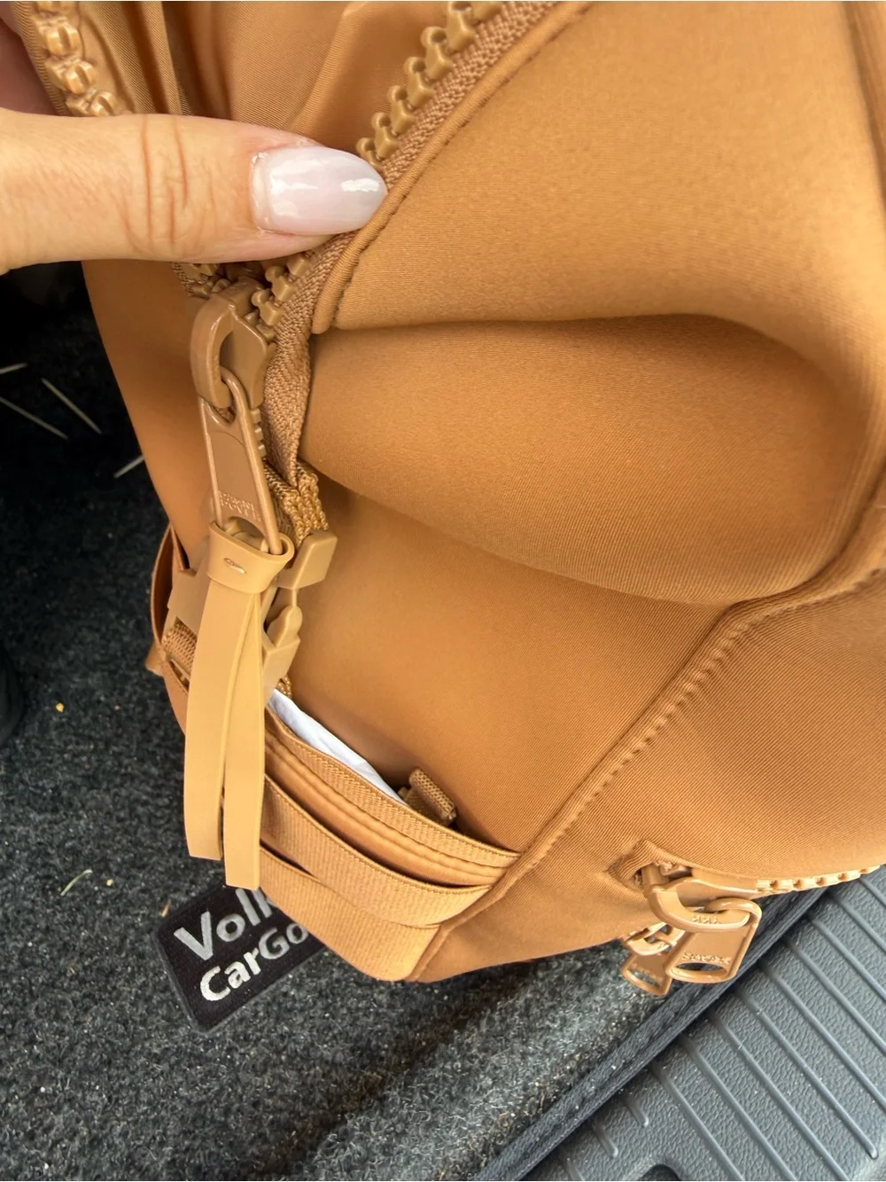 This is a Dagne Dover Dakota Neoprene Backpack in the color Camel.